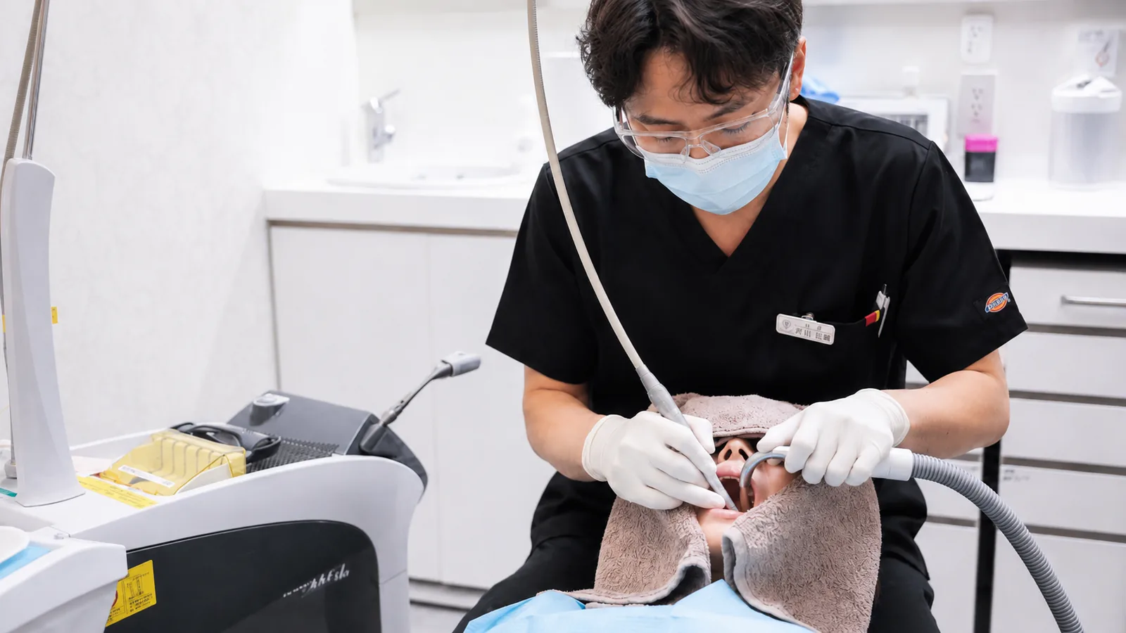 Er:YAGレーザーを使用して治療を行う院長